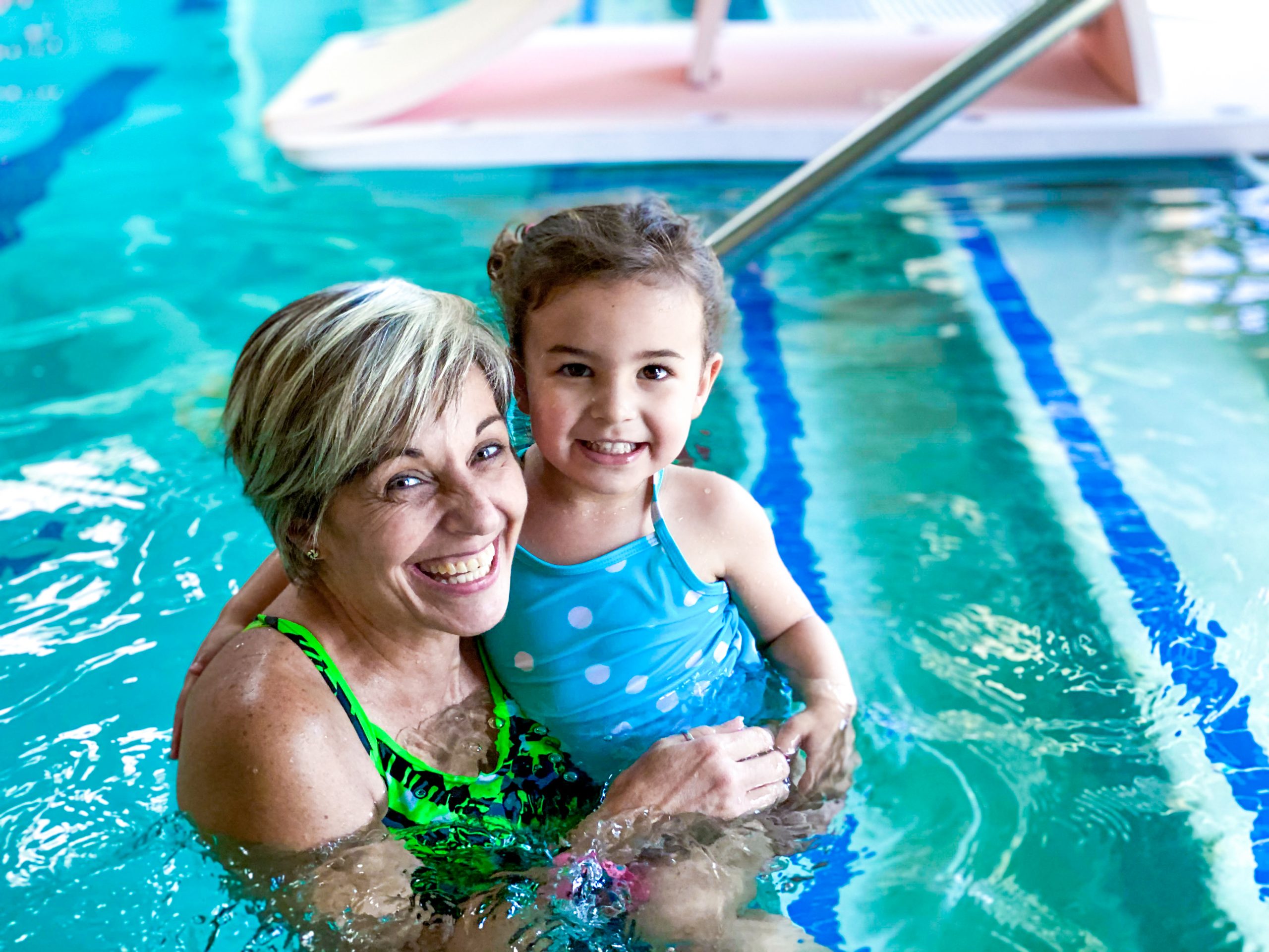 Toddler and Instructor smiling on first day of swim lessons