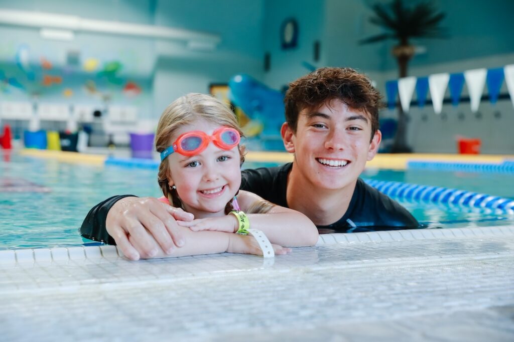 Young girl and instructor at spring swim lessons