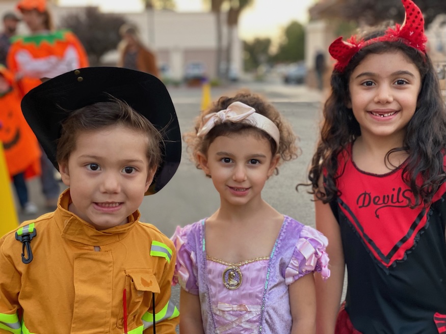 Three children having fun at a Halloween Party at America's Kids In Motion.