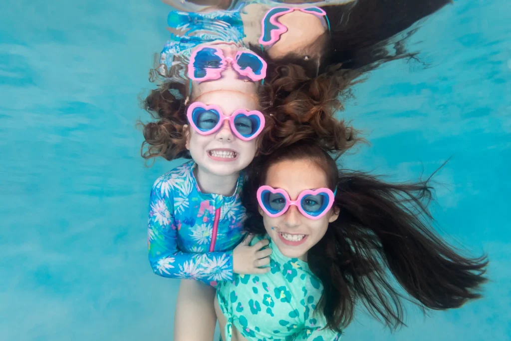Two AKIM students smiling for an underwater photo.