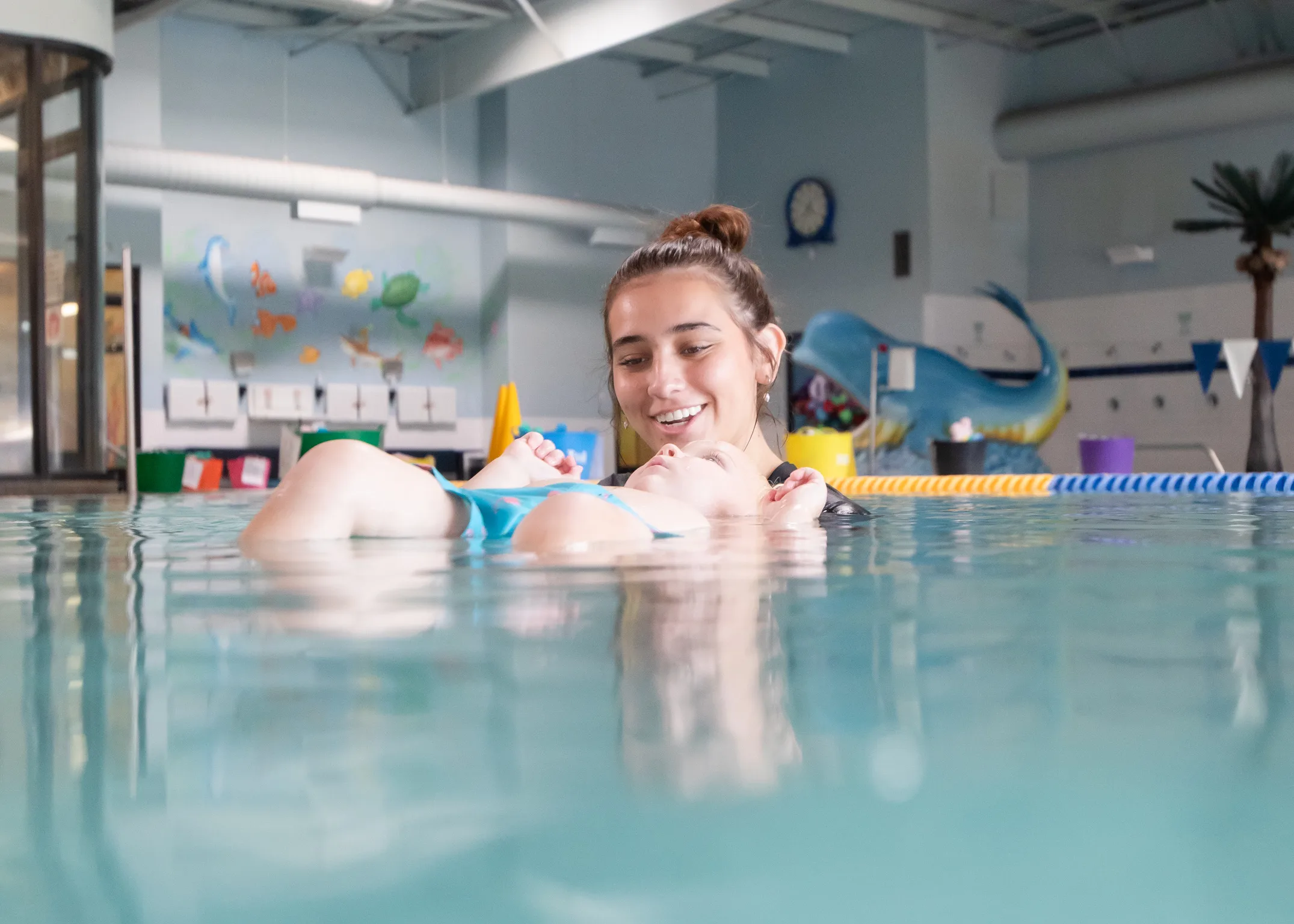 AKIM swim instructor leading infant survival swim lessons.