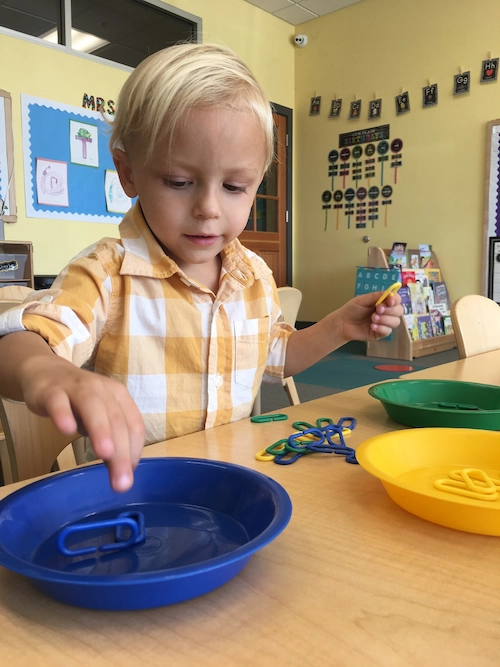 Young boy learning with hands-on tools at The Campus Preschool.