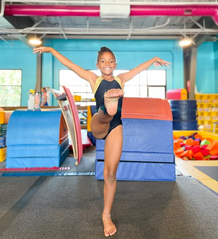 Young girl practicing gymnastics at America's Kids In Motion.